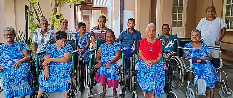 Residents of Cheshire Lanka gathered together outdoors