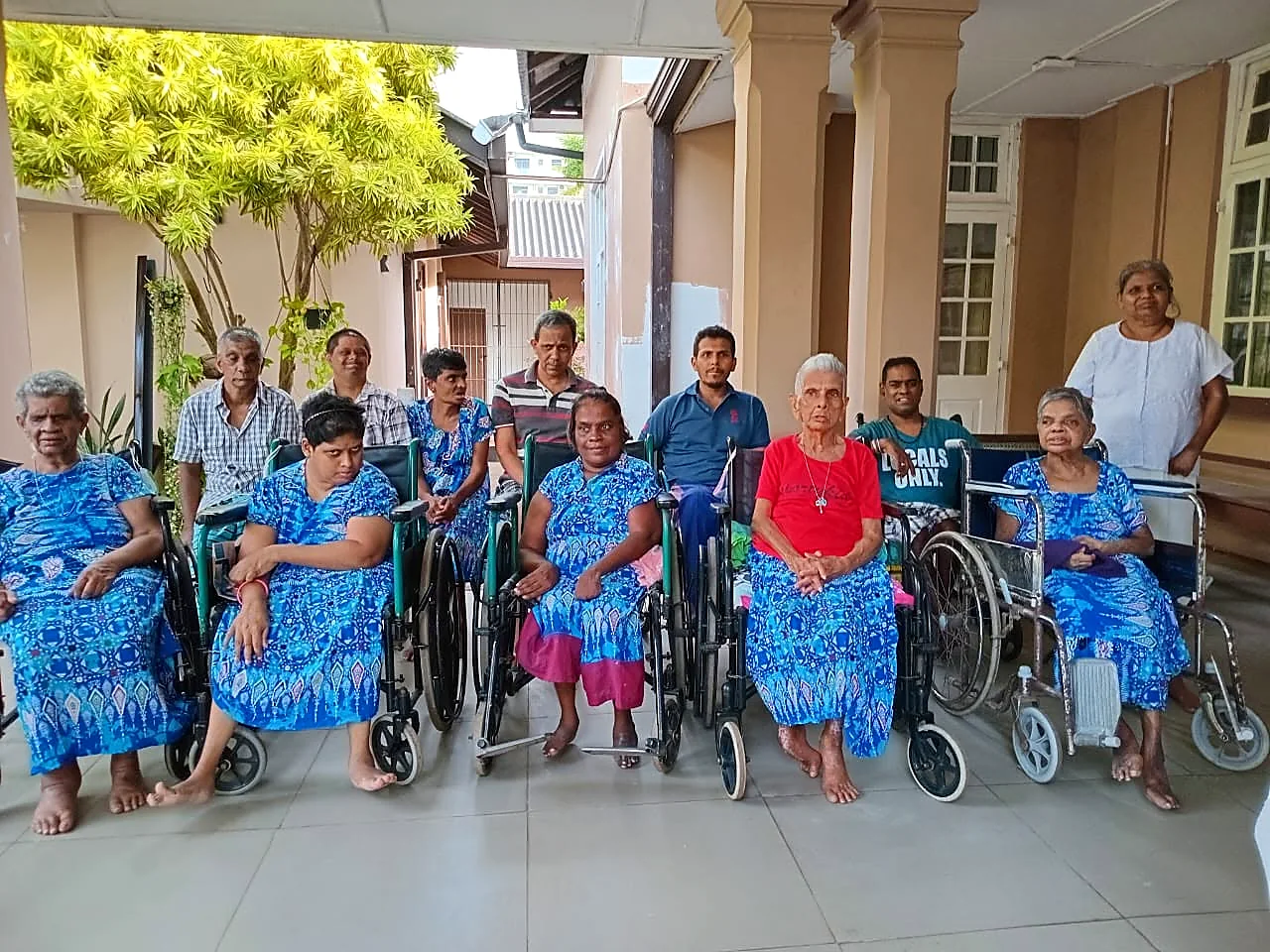 Residents and staff gathered in the courtyard at Cheshire Lanka
